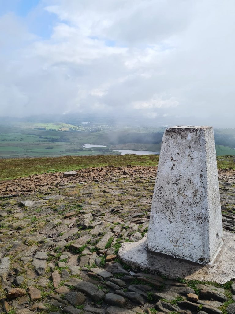 Pendle Hill trig pint with a misty overcast sky