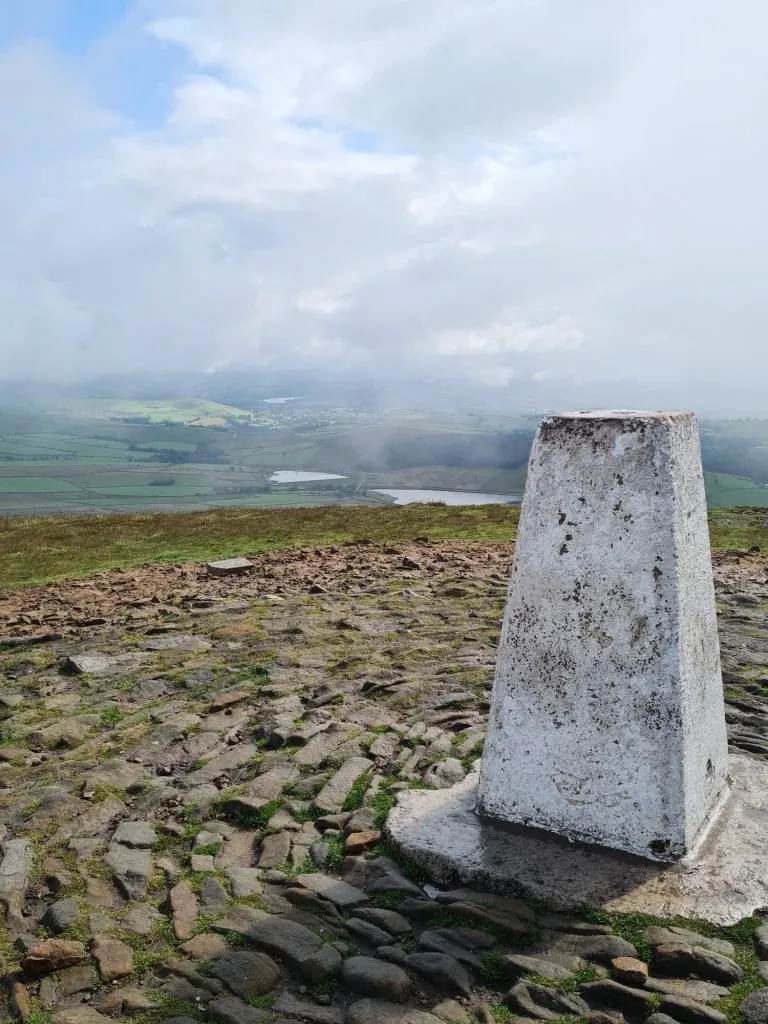 Pendle Hill trig pint with a misty overcast sky