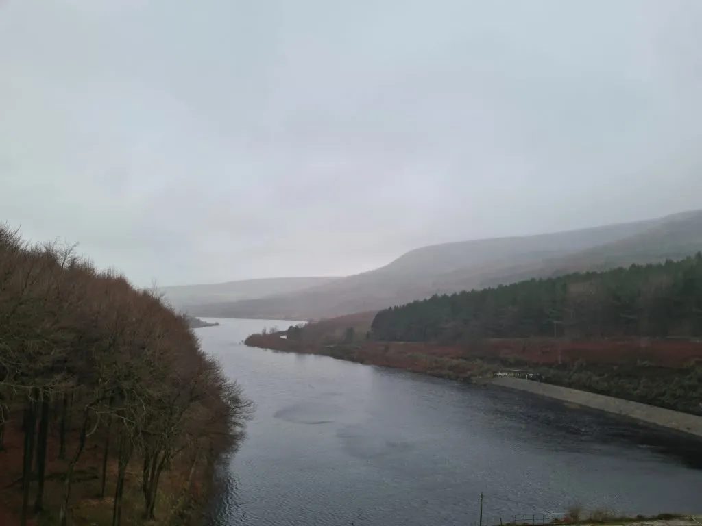 Views down a misty Rhodeswood Reservoir in Winter