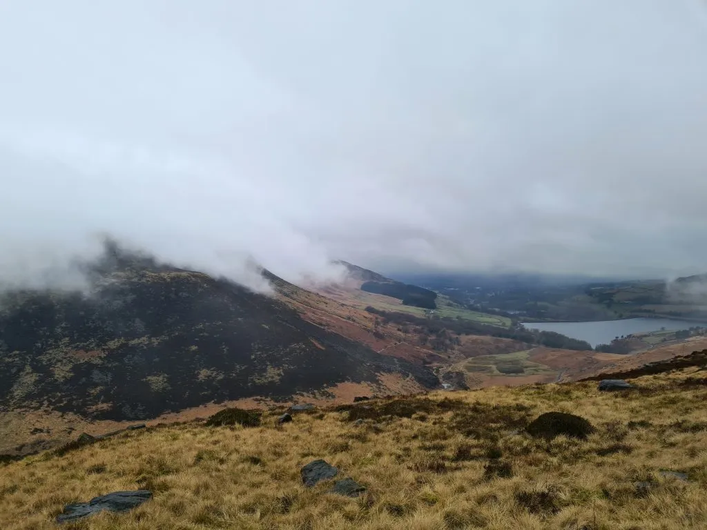 Mist rolling up over the moors with Dovestone Reservoir down in the valley bottom