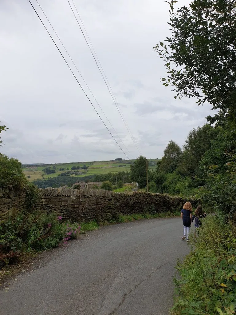 A countryside lane near Holmfirth with two girl walking together