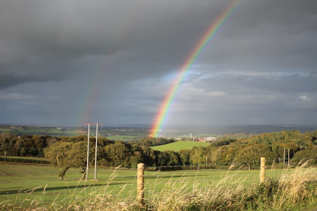 Rainbow against a dark cloudy sky in Ingbirchworth