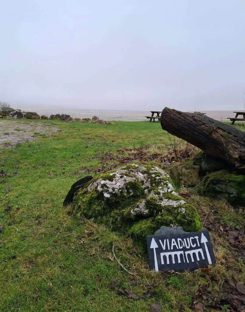 Ribblehead Viaduct in the mist with a sign saying Viaduct
