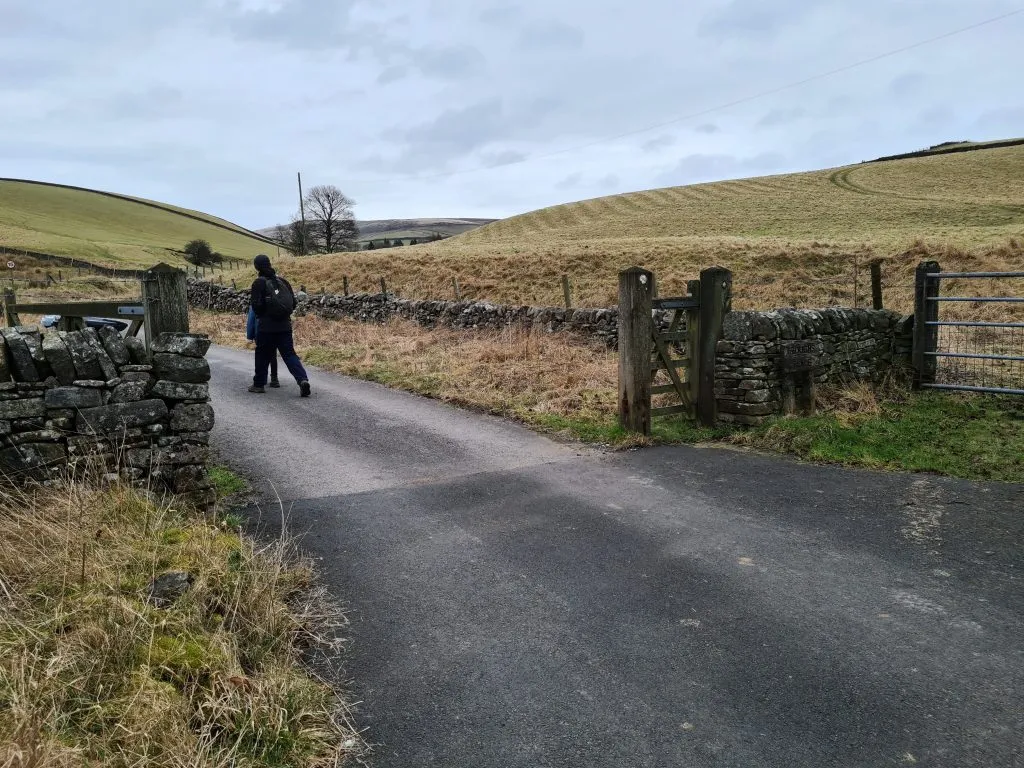 A man walking up a farm track - Shutlingsloe circular walk via Whetstone Ridge by The Wandering Wildflower