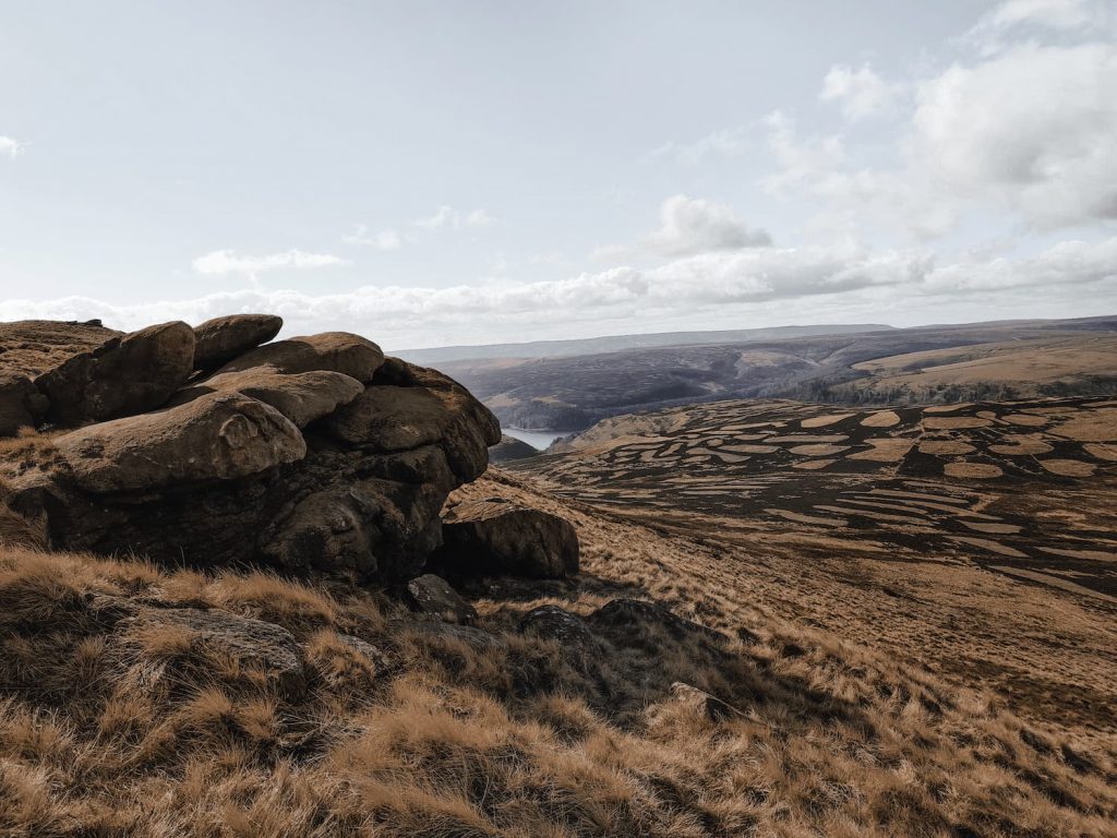 Rock formations on Howden Edge with views down to Howden Reservoir