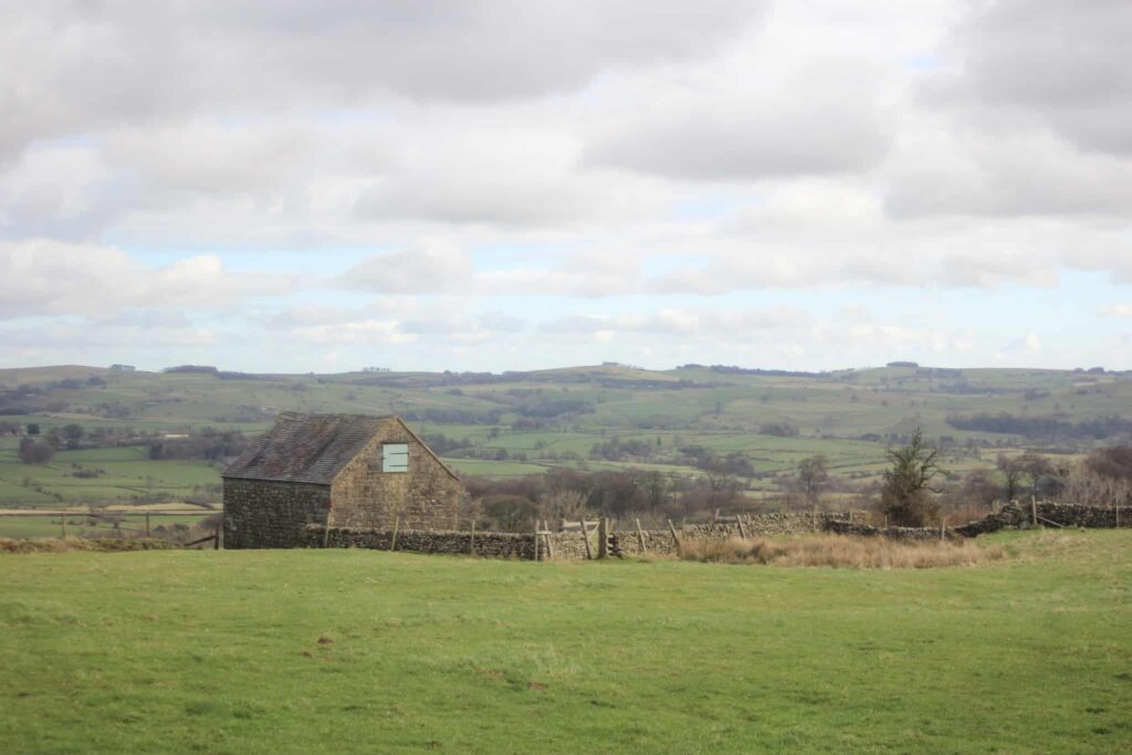 An old stone barn in a field