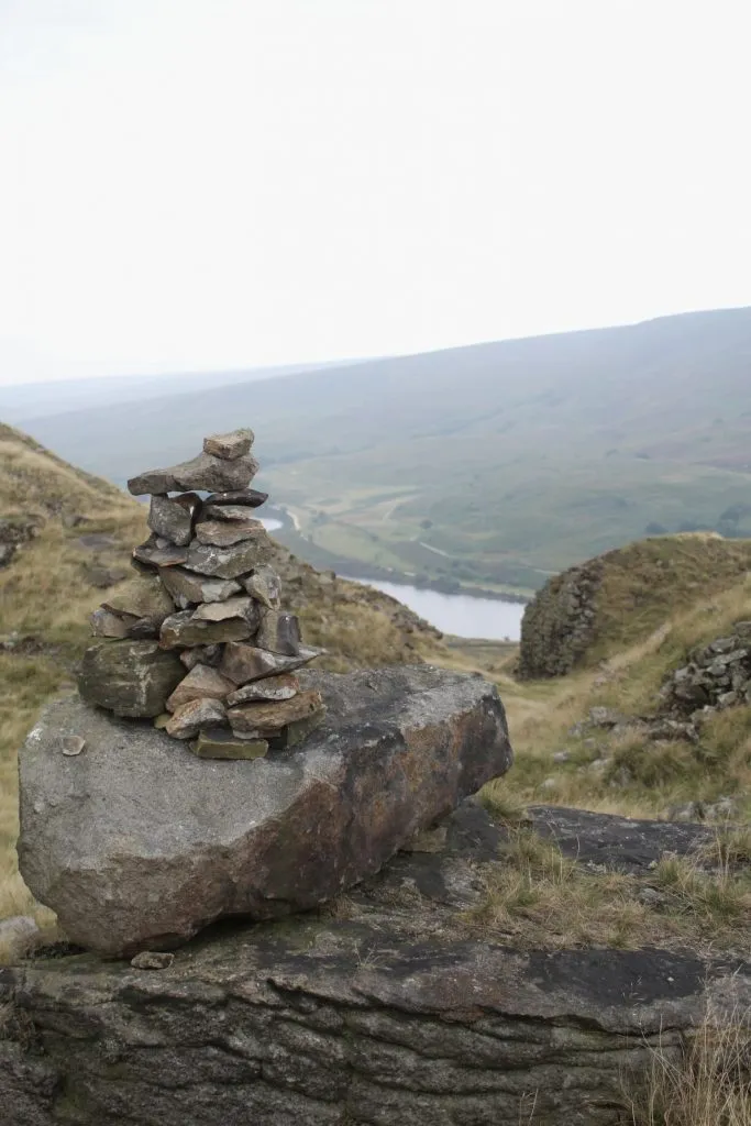 A small pile of rocks with a reservoir view in the background