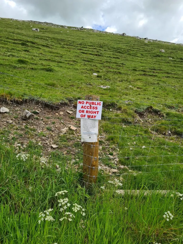 A white sign with red writing "No Public Access or Right of Way"