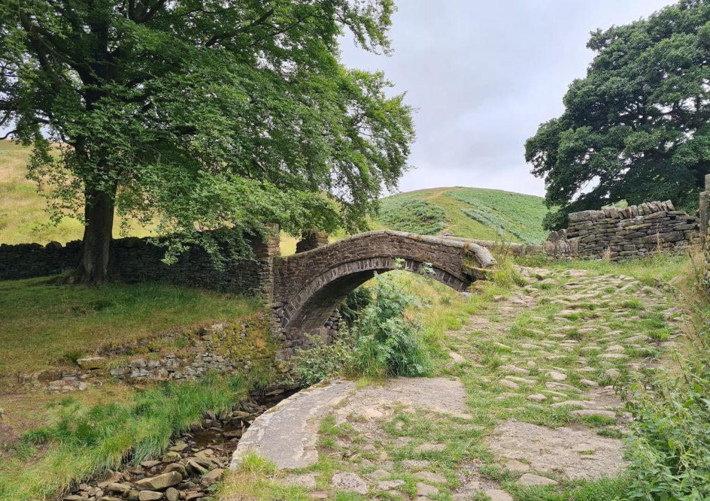 A beautiful old stone packhorse bridge, Eastergate Bridge in Marsden, West Yorkshire