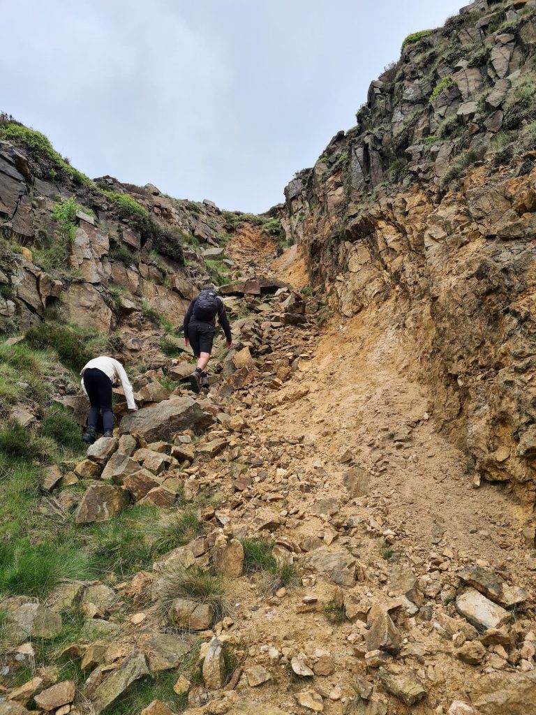 A father and daughter climbing up Dowstone Clough, Peak District scrambles