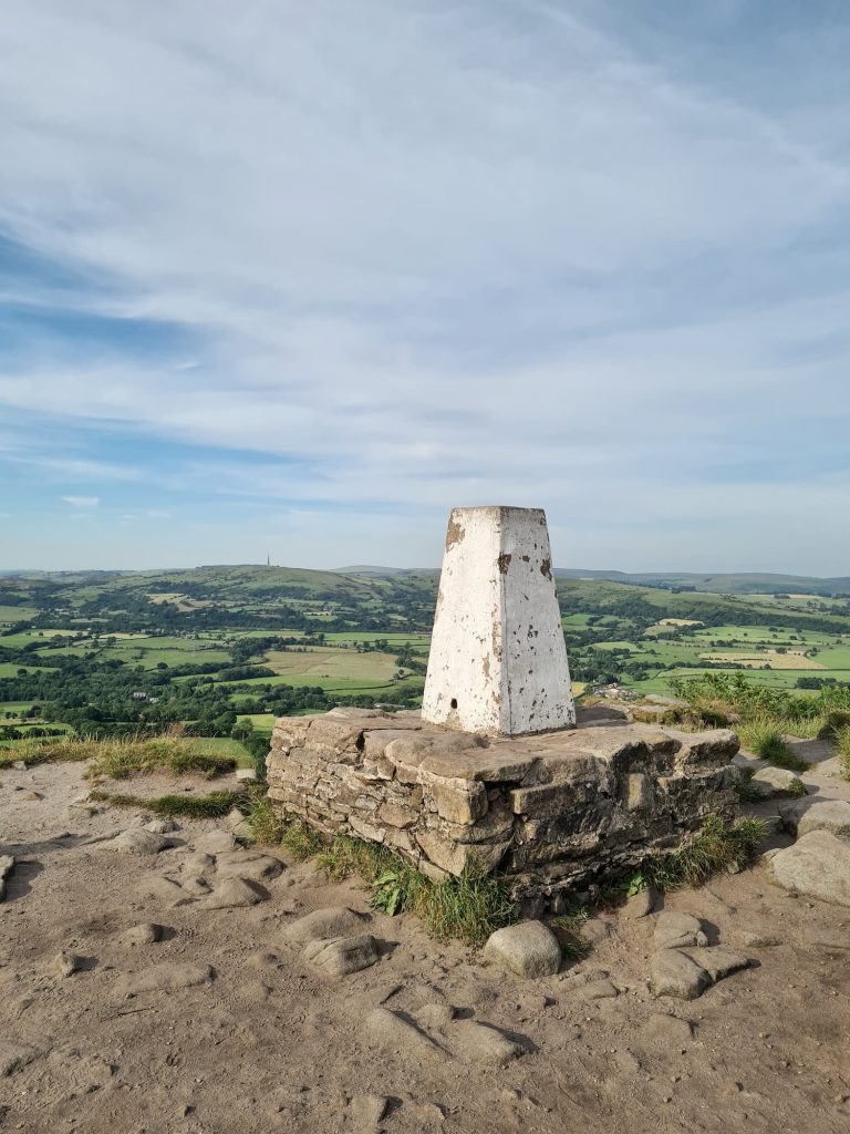 The Cloud at Bosley trig point on a stone plinth with amazing views over Peak District countryside