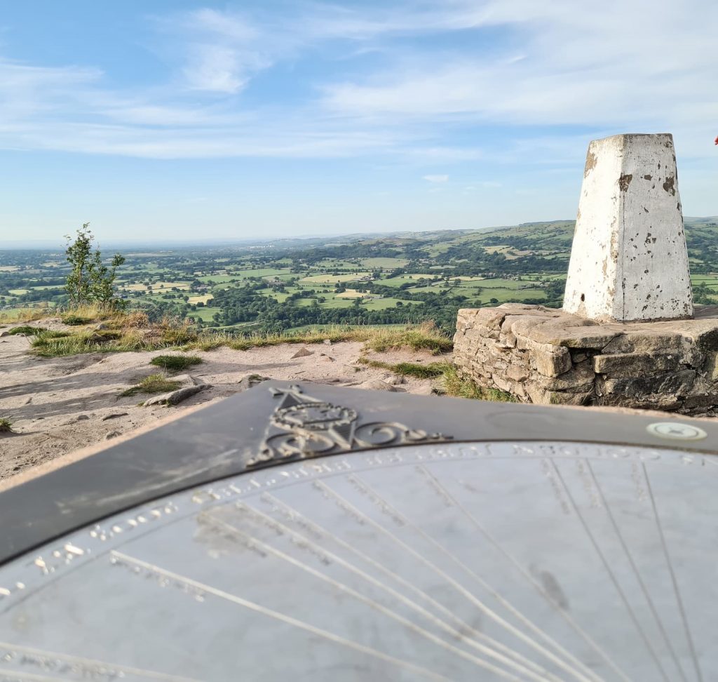 The Cloud at Bosley trig point on a stone plinth with amazing views over Peak District countryside