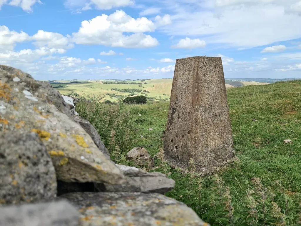 Musden Low trig point as seen from over the wall
