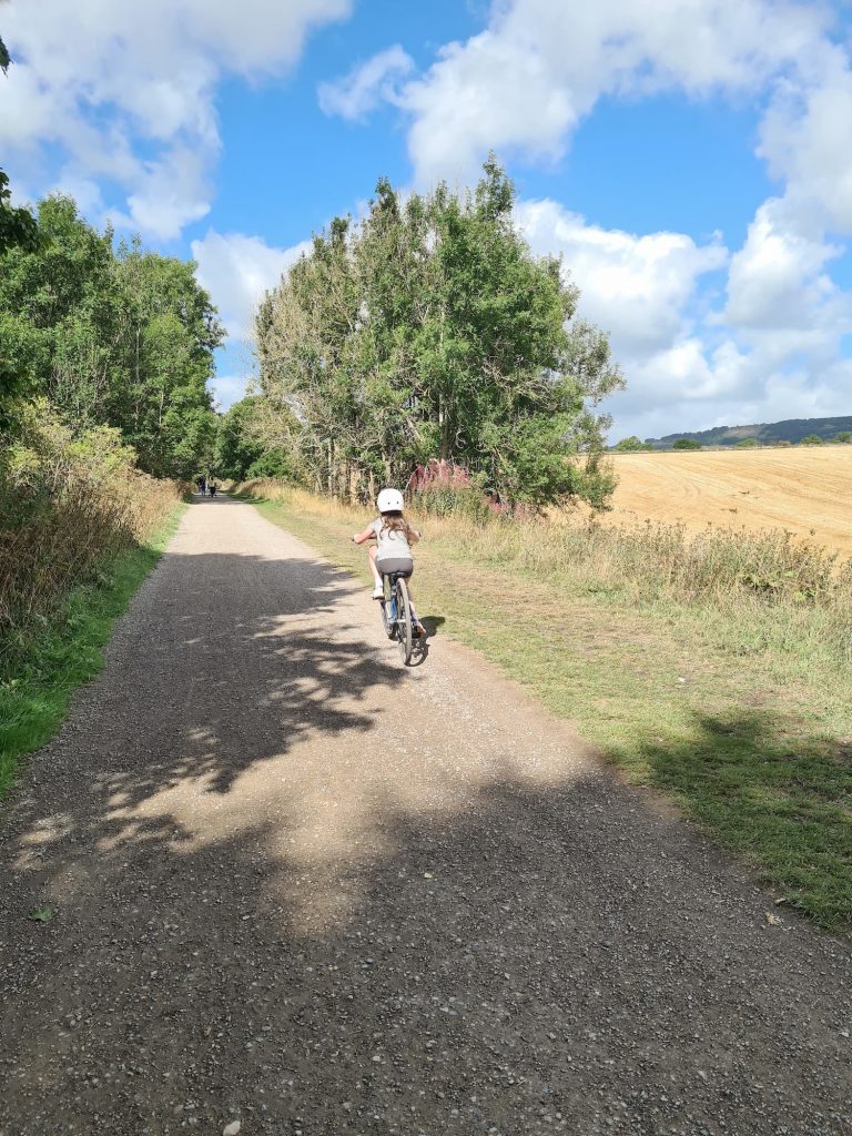 Small girl cycling on the Monsal Trail - The Wandering Wildflower