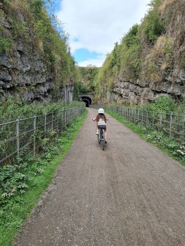 Small girl cycling on the Monsal Trail - The Wandering Wildflower