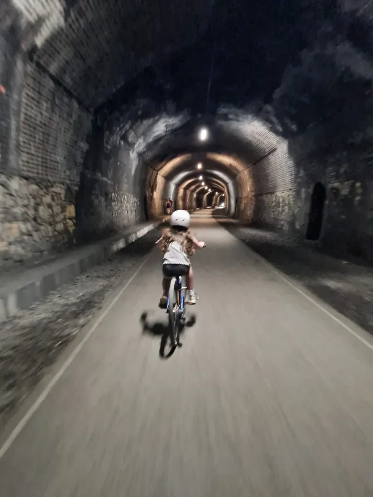 Small girl cycling on the Monsal Trail - The Wandering Wildflower
