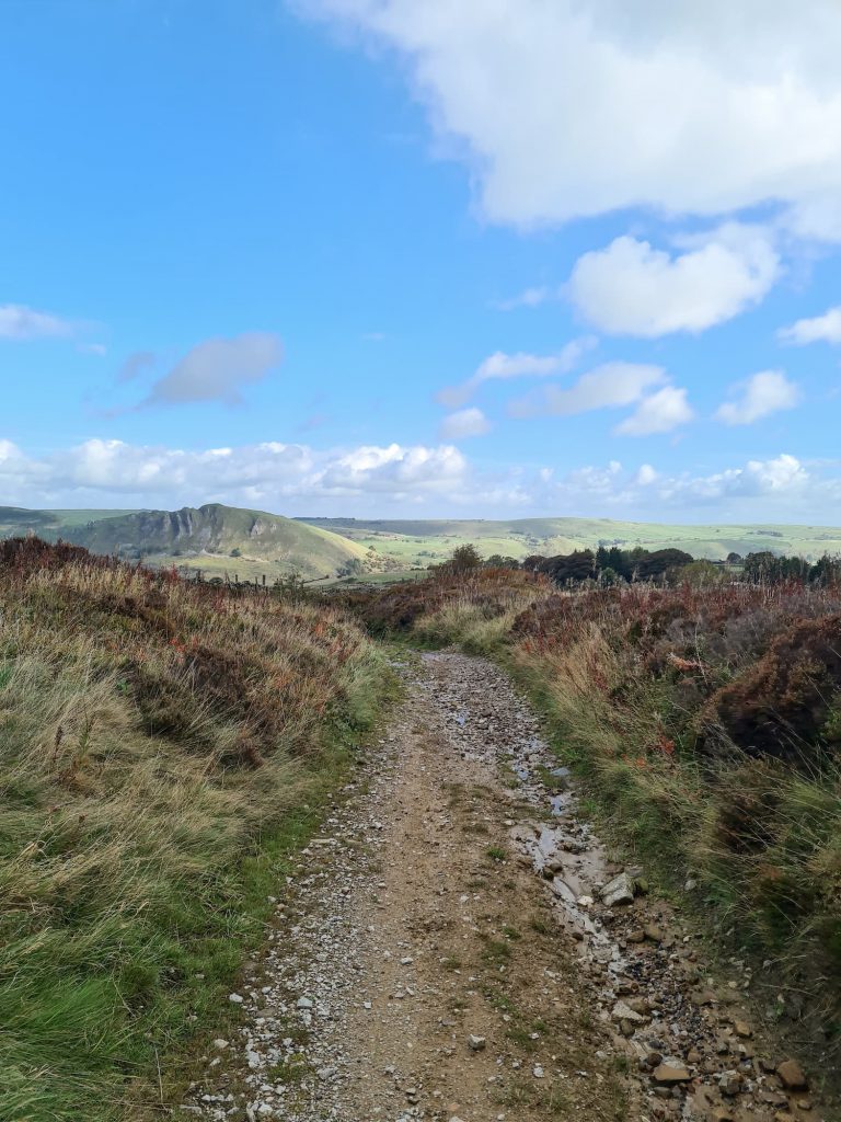 A gravel track with a view of Chrome Hill - The Wandering Wildflower