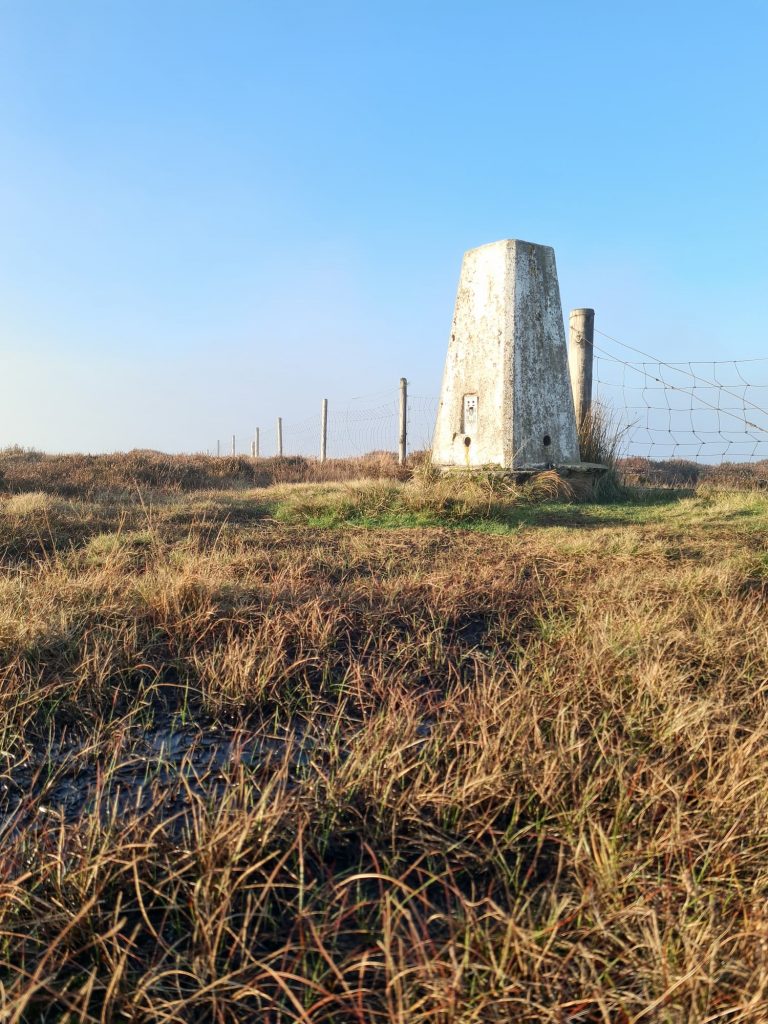 Dead Edge End trig point with blue skies behind