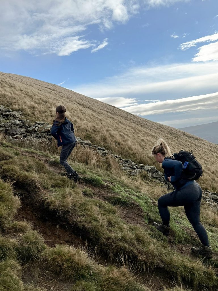 A woman and her daughter walking up a very steep hill