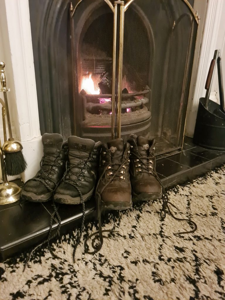 Walking boots drying in front of an open coal fire