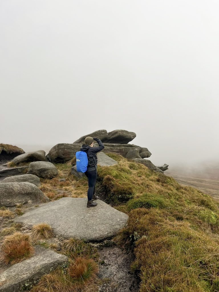 A woman stood on a rock in the mist