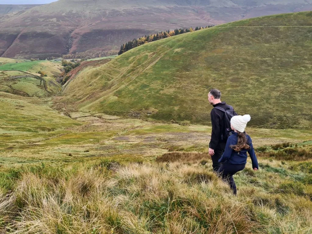 A father and daughter walking on the moors