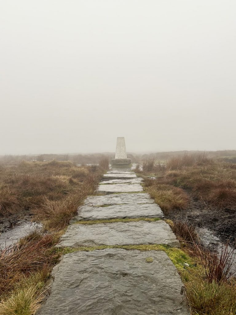 A stone slab path leading to Brown Knoll trig point