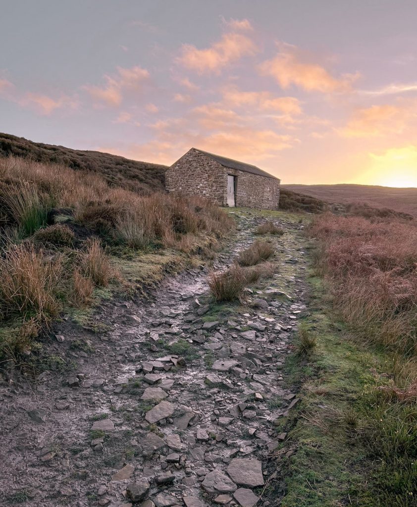 A Peak District shooting cabin at sunset