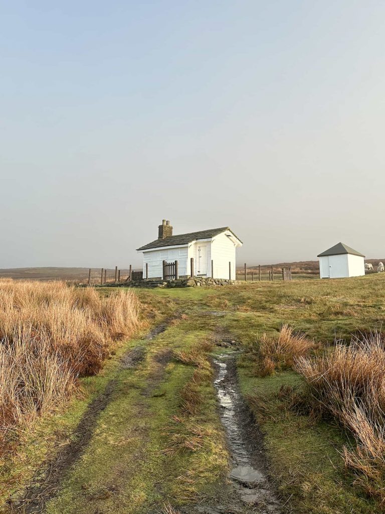 A white shooting cabin on the moors near Kinder Scout