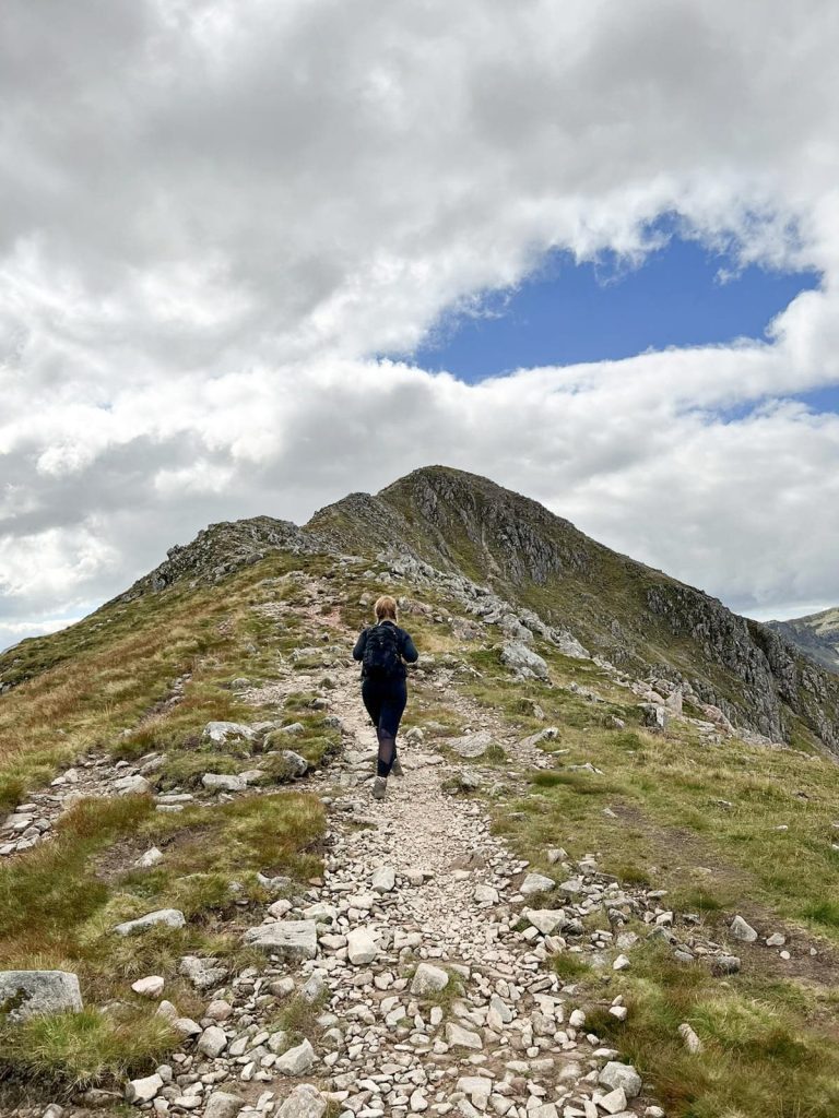 A woman walking on the ridge between Stobh Dubh and Stobh Coire Raineach