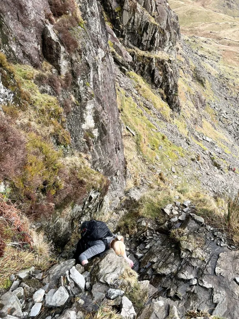 A view down to a woman scrambling up Jack's Rake