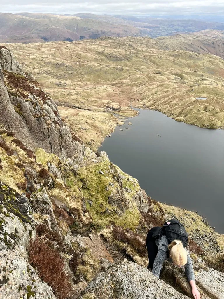 A view down to a woman scrambling up Jack's Rake