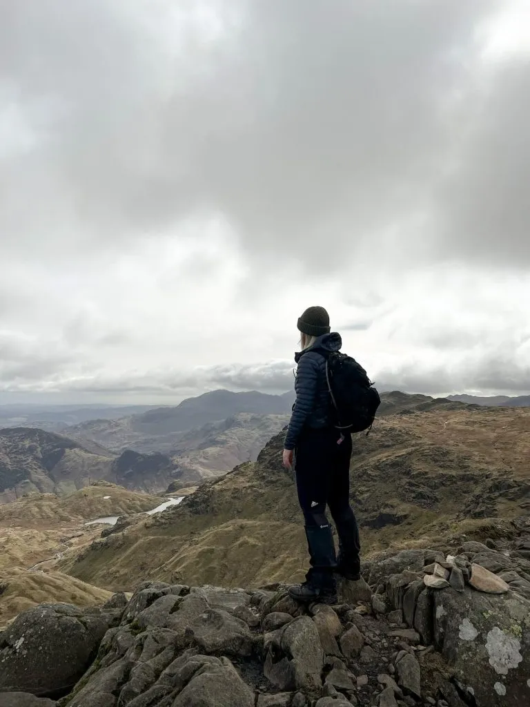 A woman posing admiring the view from Pavey Ark