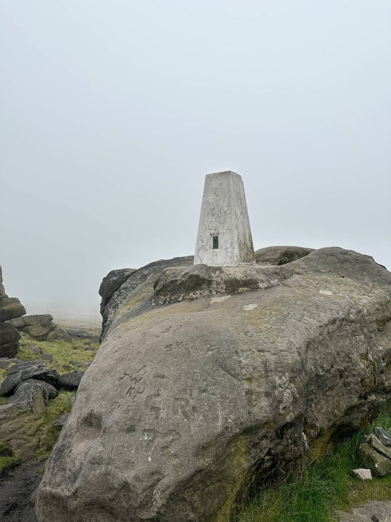 Blackstone Edge trig pillar, a white painted concrete pillar set in the rocks