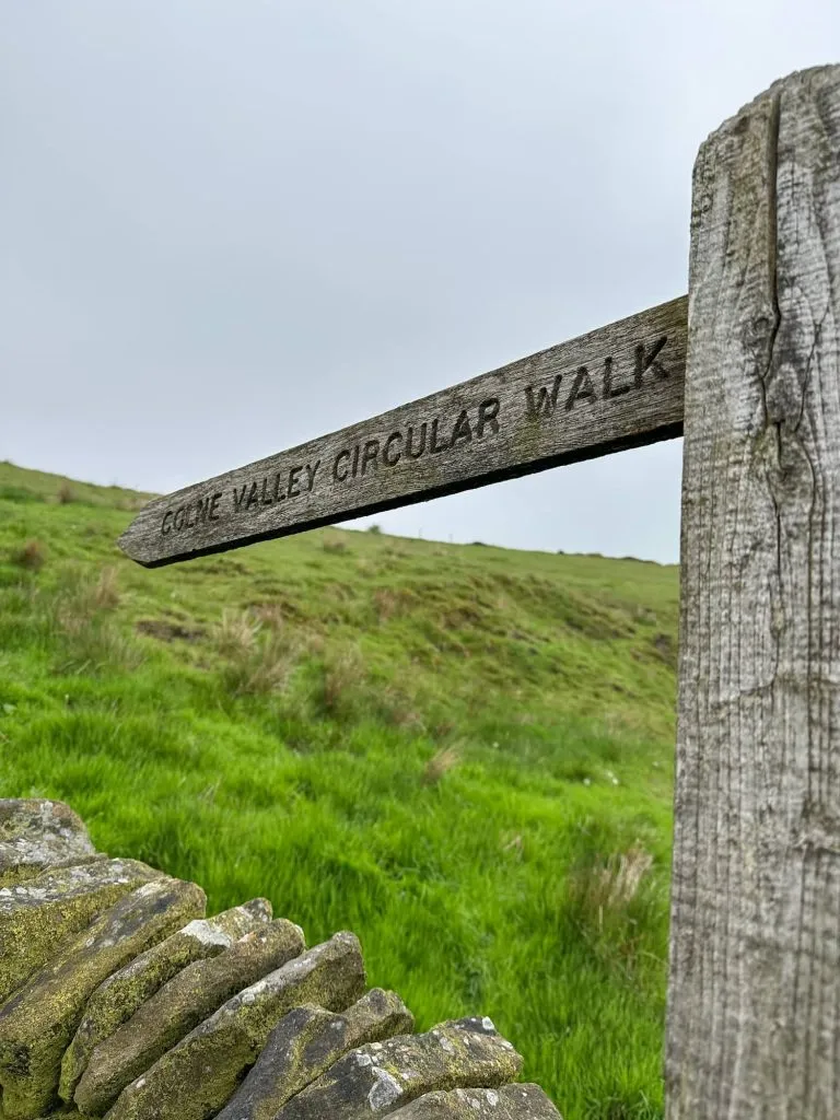 A wooden sign post with the Colne Valley Circular Walk marked