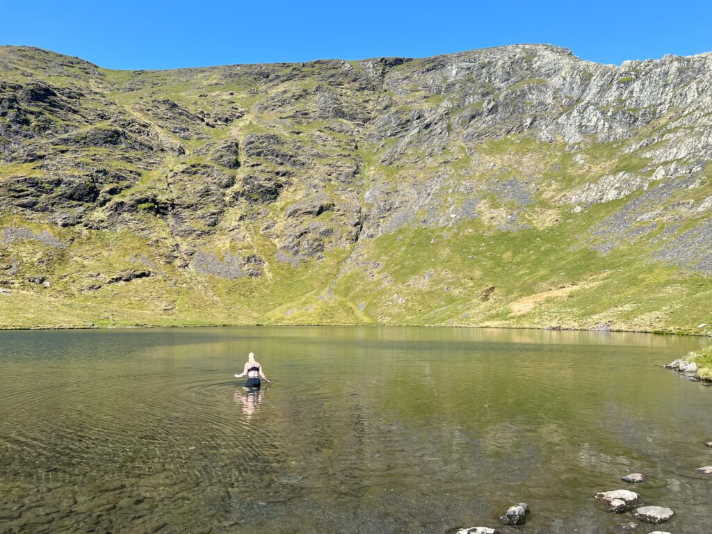 A woman wading in Scales Tarn