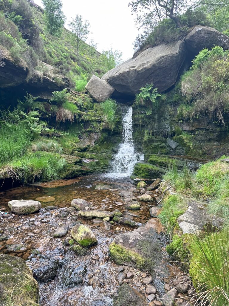 Near Black Clough waterfall, with lush greenery