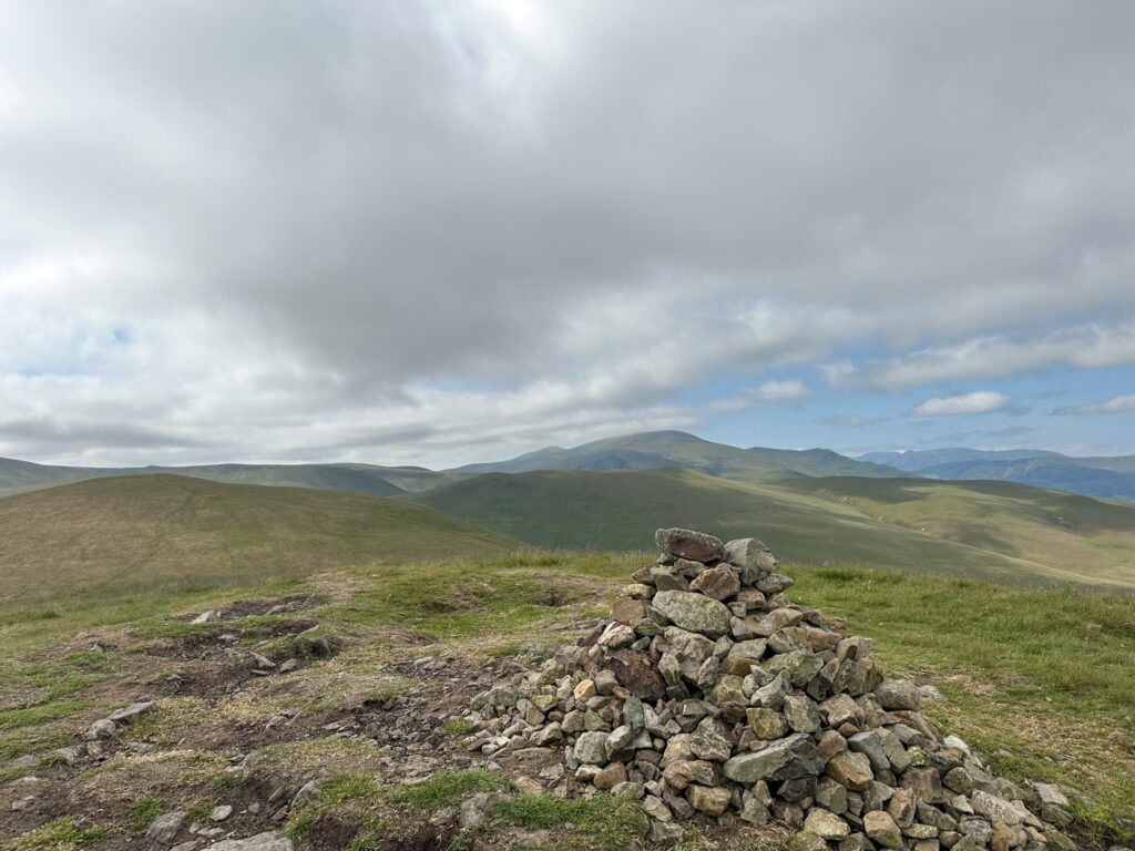 A cairn, a pile of stones at the summit of Longlands Fell