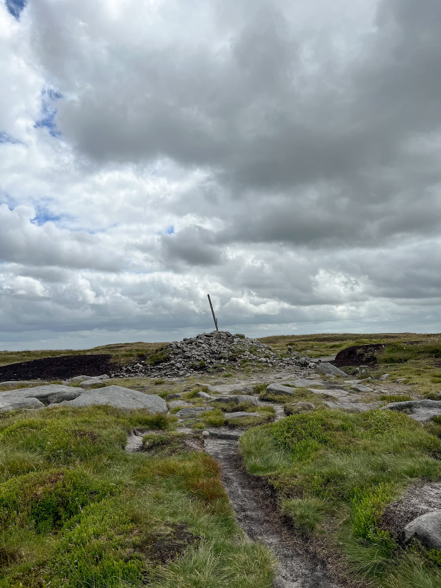 Bleaklow Head summit marker, a 6 foot tall pole in a pile of rocks