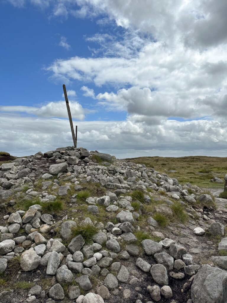 Bleaklow Head summit marker, a 6 foot tall pole in a pile of rocks