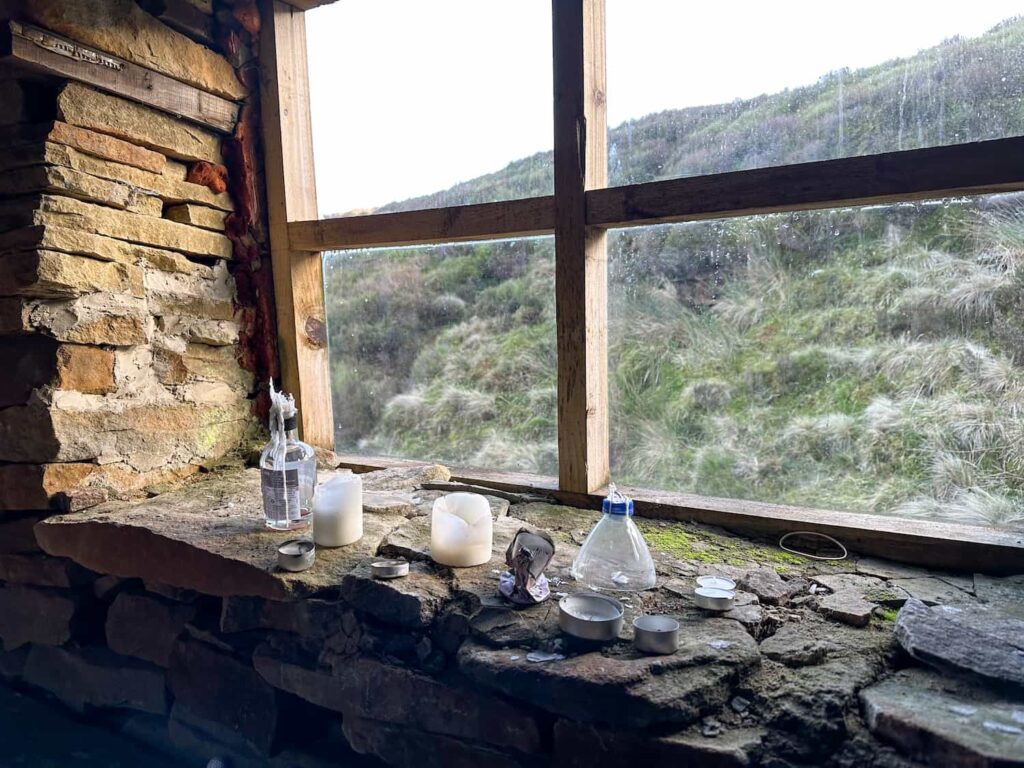 A view from an old shooting cabin window, with candles on the window sill