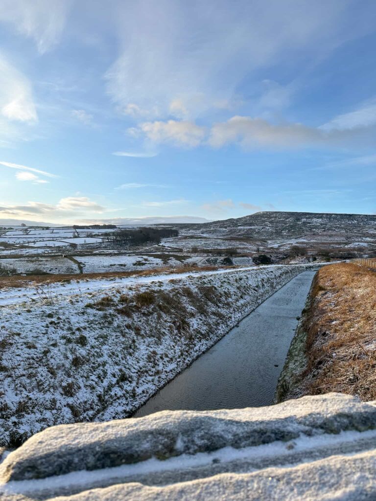 A snowy view of Meltham Catch, a channel to catch rainwater