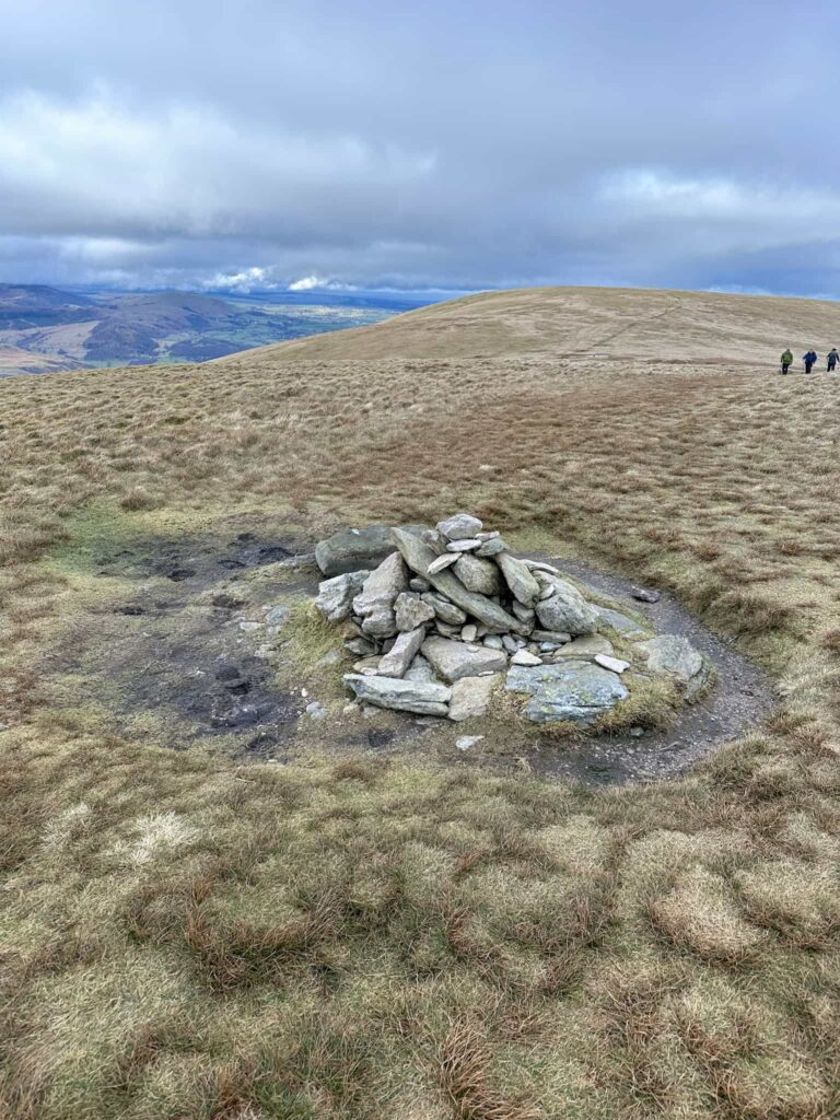 A small pile of stones marking the summit of Wether Hill