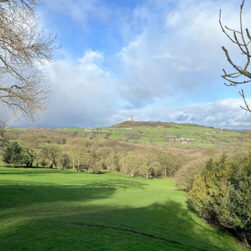 A view of Castle Hill from Farnley Tyas - green fields and blue skies