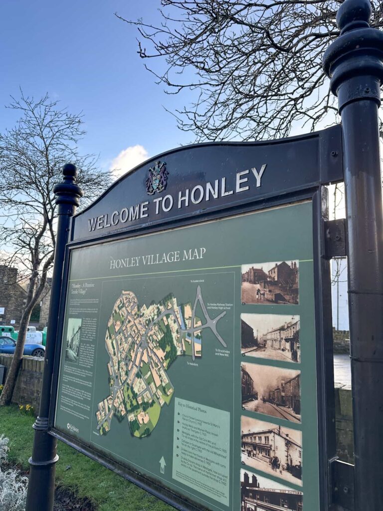 A noticeboard saying "Welcome to Honley"