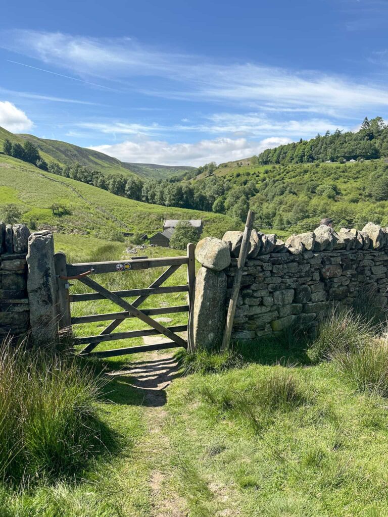 A gate with a view of Blackden Barn