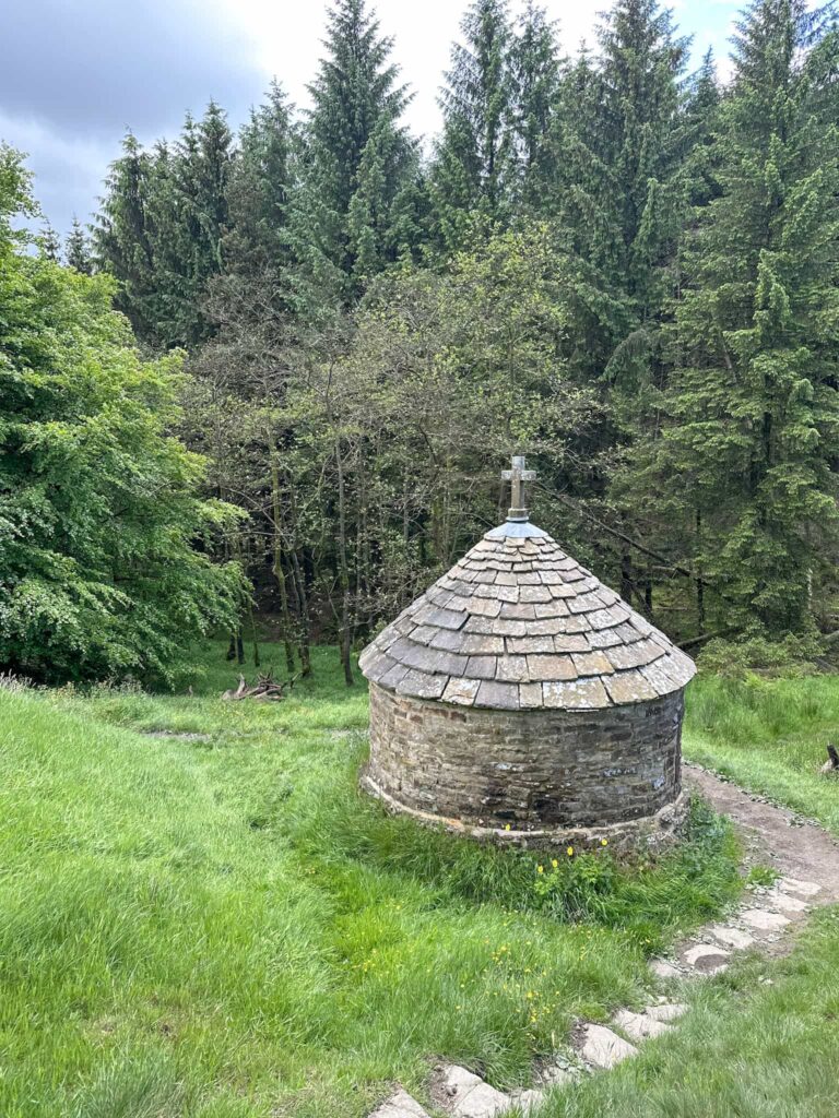 Looking down the hillside to St Joseph's Shrine at Errwood Hall, small round chapel building