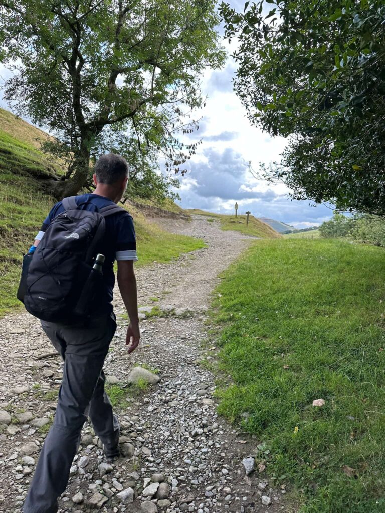 A man walking on a stony track