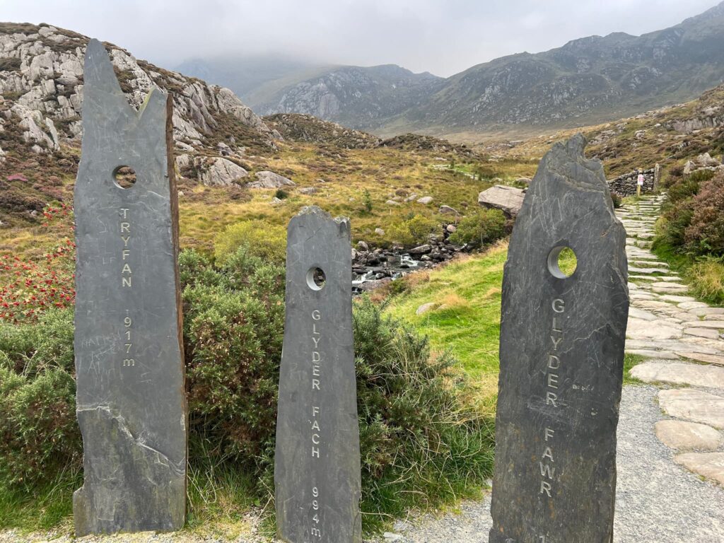 3 slate markers with the names of mountains carved into them