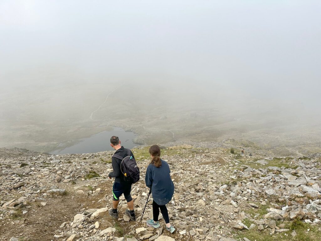 A man and his daughter descending Glyder Fawr